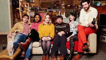 Cast of Fresh Meat on Channel 4 sitting on a sofa