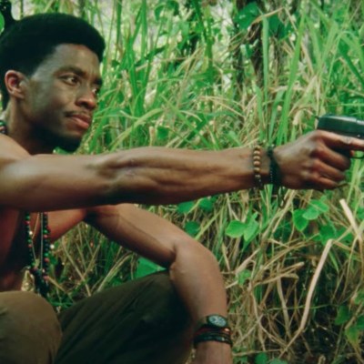 Chadwick Boseman Holding Gun in Da 5 Bloods