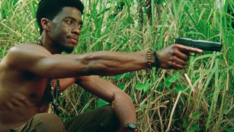 Chadwick Boseman Holding Gun in Da 5 Bloods