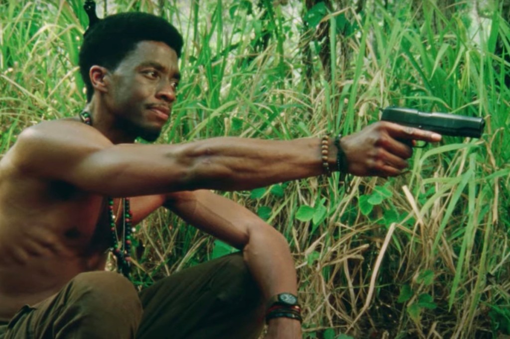 Chadwick Boseman Holding Gun in Da 5 Bloods