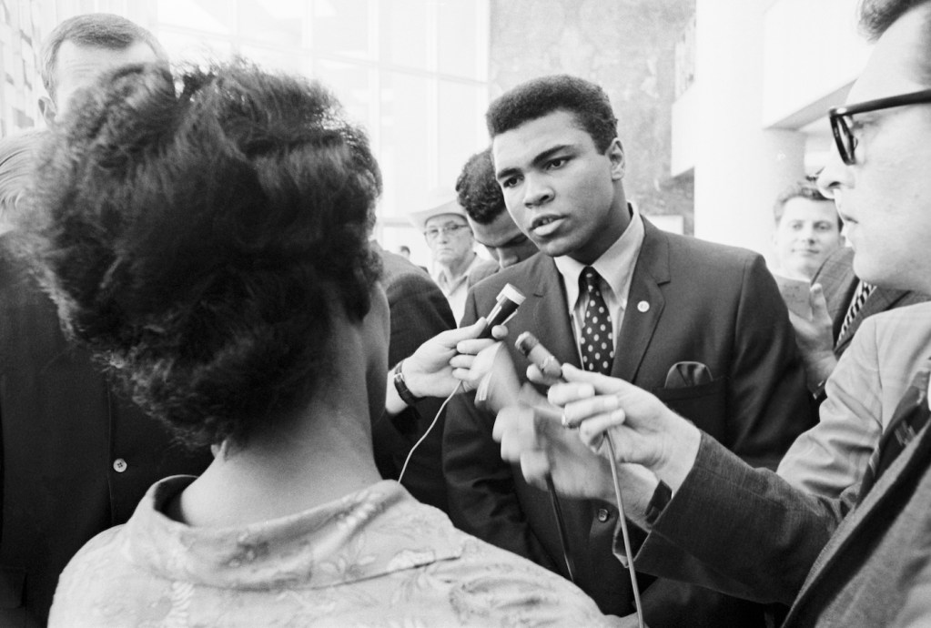 Muhammad Ali talking with the press