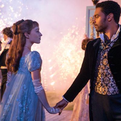 Bridgerton's Daphne and Simon dance together as sparks glow in the background