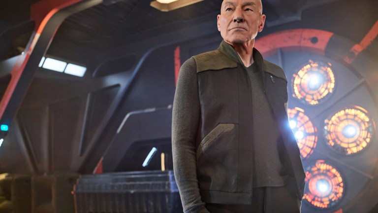 Patrick Stewart as Jean-Luc Picard stands on the bridge of a ship