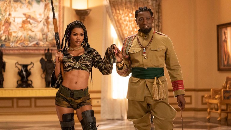 Wesley Snipes and Teyana Taylor holding weapons in Coming 2 America