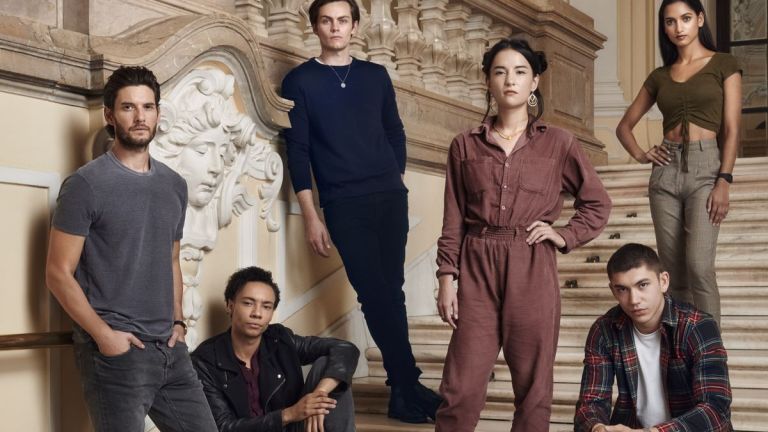 The Cast of Netflix's Shadow and Bone stand on some stairs