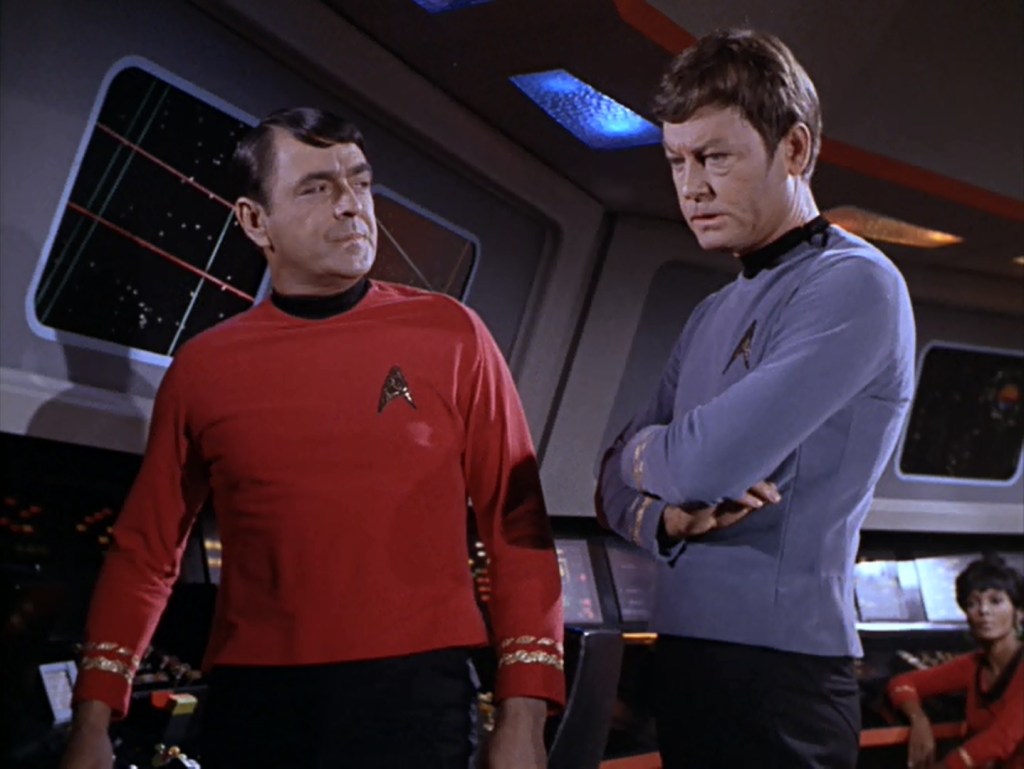 Scotty and Bones stand on the bridge in "A Taste of Armageddon"