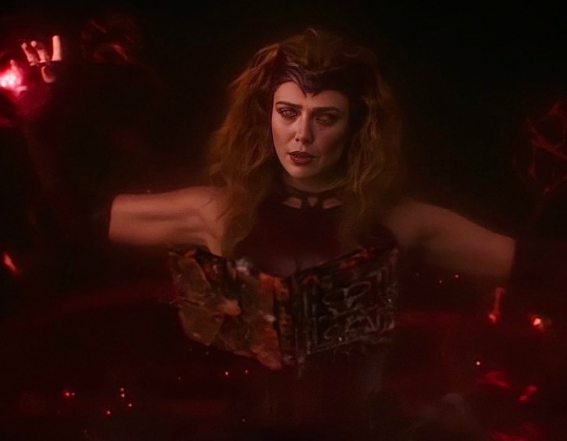 Elizabeth Olsen as Scarlet Witch reading the Darkhold in WandaVision
