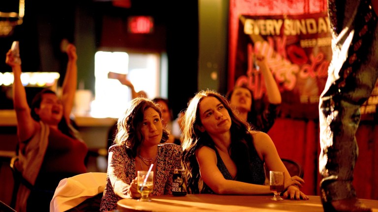 Waverly and Wynonna sit at a strip club together in Wynonna Earp Season 4