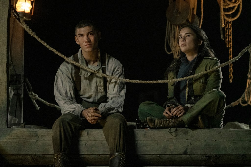 Mal and Alina sit on a dock together