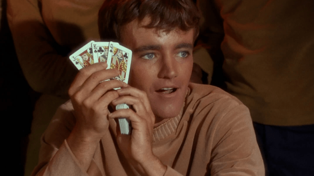 Charlie Evans holds up some cards in Star Trek: The Original Series