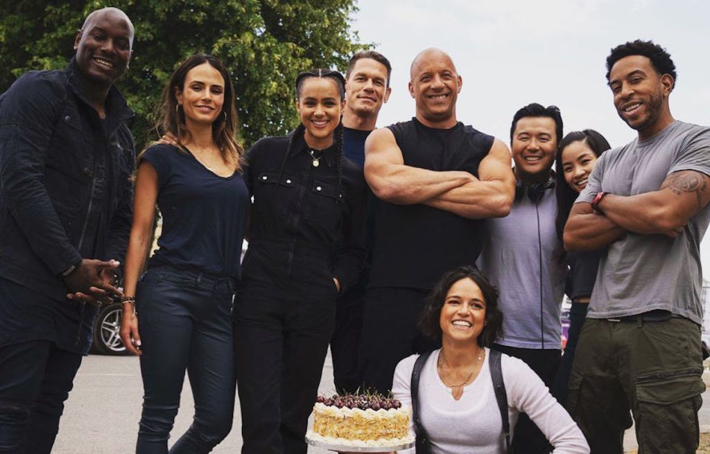 Cast of F9 posing for picture with cake