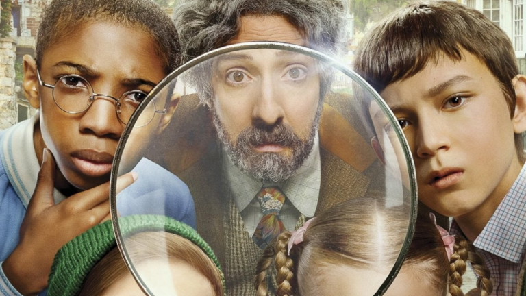 Three characters from The Mysterious Benedict Society series look at the camera through a magnifying glass