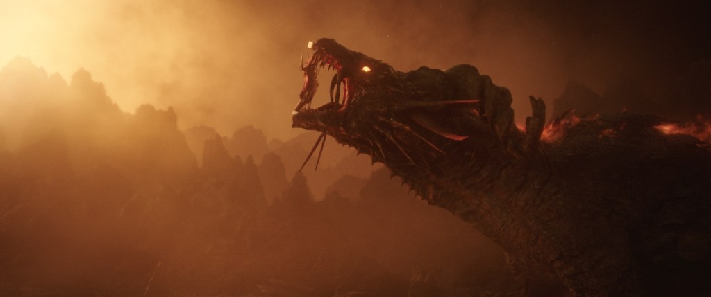 Thor holds the jaws of Fire Dragon of Muspelheim open in Thor: Ragnarok