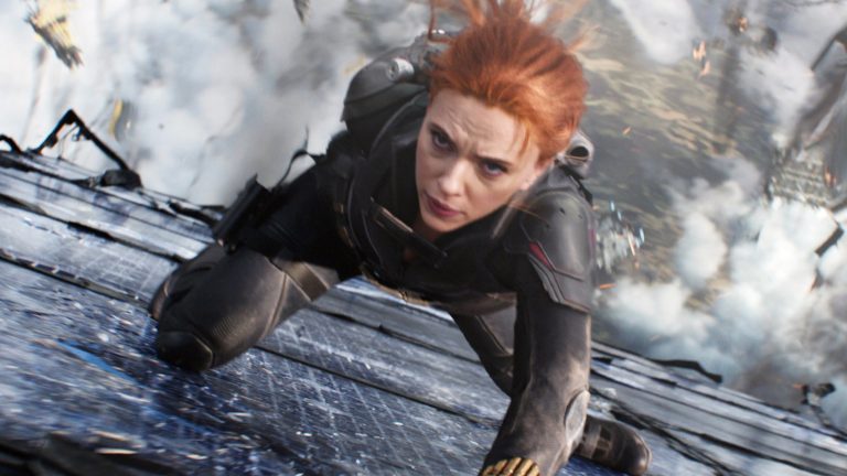 Natasha Romanov as the Black Widow slides down the side of a falling structure