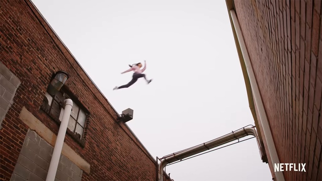Cobra Kai Season 4; Samantha jumps off a roof.