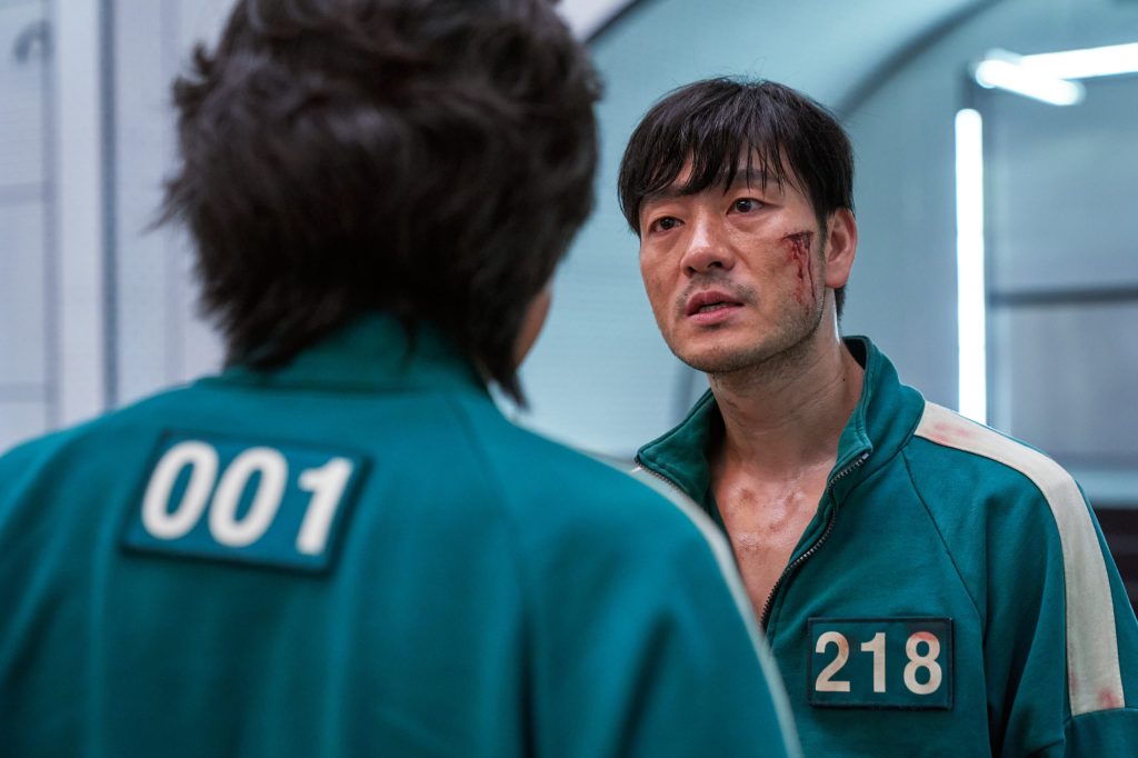 Gi-hun and Sang-woo face off in the Squid Game ending