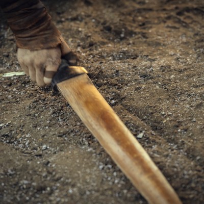 Hand grabbing sword on the ground