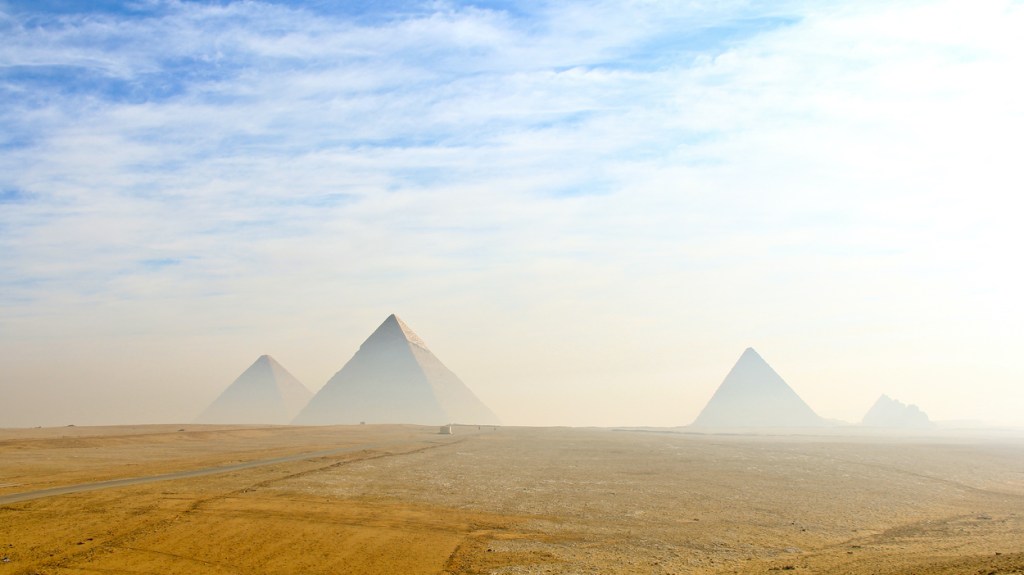The Pyramids of Giza under a blue sky