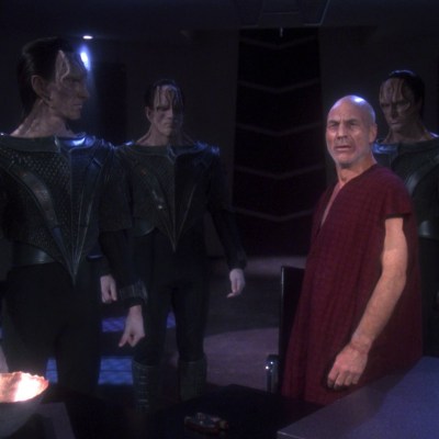 An exhausted Jean-Luc Picard stands amongst his Cardassian torturers in Star Trek episode The Chain of Command