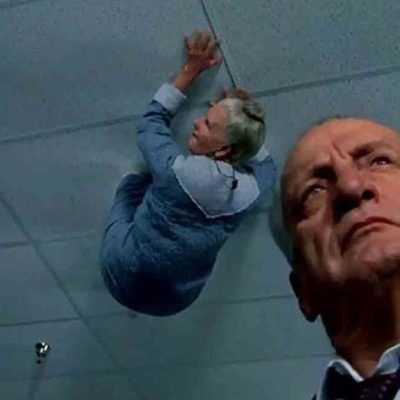 Old person crawling and George. Scott in The Exorcist III