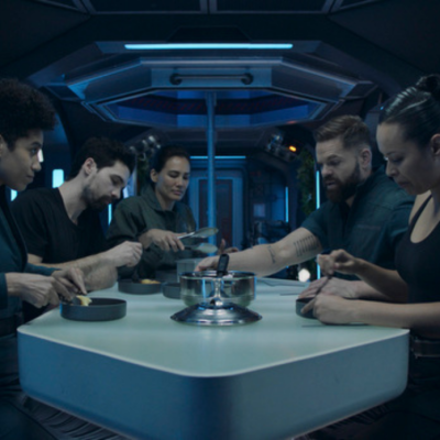 The crew of the Roci sits around the dinner table in The Expanse series finale