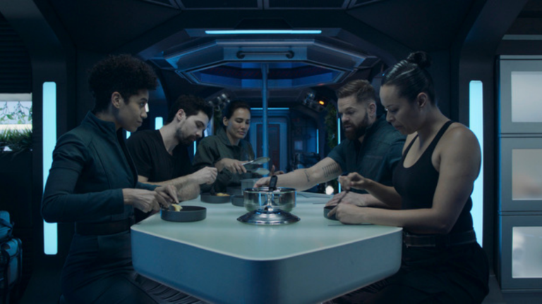 The crew of the Roci sits around the dinner table in The Expanse series finale