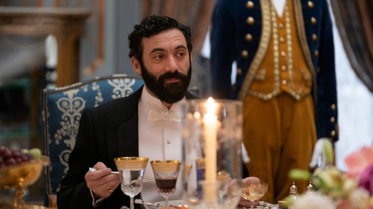 George Russell sits at an ornately set table in The Gilded Age Episode 3