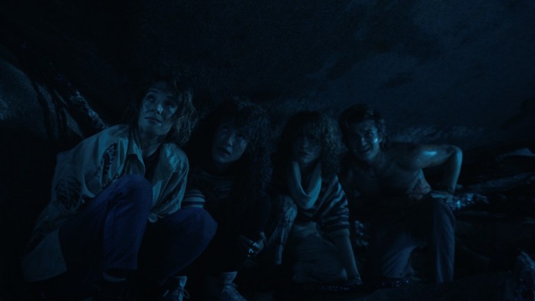 Robin (Maya Hawke), Eddie (Joseph Quinn), Nancy (Natalia Dyer), and Steve (Joe Keery) in the Upside Down in Stranger Things season 4