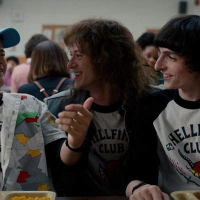 Dustin Henderson (Gaten Matarazzo), Eddie Munson (Joseph Quinn), and Mike Wheeler (Finn Wolfhard) at the lunch table in Stranger Things season 4