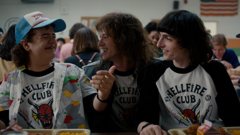 Dustin Henderson (Gaten Matarazzo), Eddie Munson (Joseph Quinn), and Mike Wheeler (Finn Wolfhard) at the lunch table in Stranger Things season 4