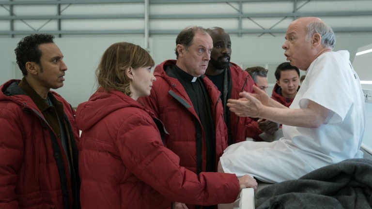 Ben (Aasif Mandvi), Kristen (Katja Herbers), and David (Mike Colter) gather around Wallace Shawn in Evil season 3