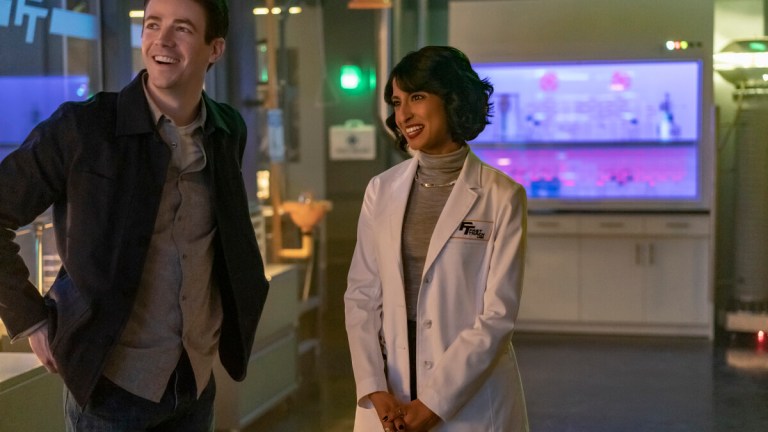 The Flash -- "The Man in the Yellow Tie" -- Image Number: FLA818a_0207r.jpg -- Pictured (L-R): Grant Gustin as Barry Allen and Kausar Mohammed as Dr. Meena Dewan -- Photo: Colin Bentley/The CW -- 2022 The CW Network, LLC. All Rights Reserved.