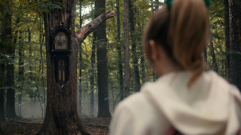 A grandfather clock in the woods in Stranger Things season 4