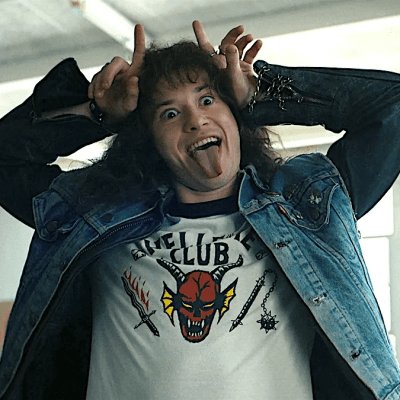 Eddie Munson makes devil horns in Stranger Things