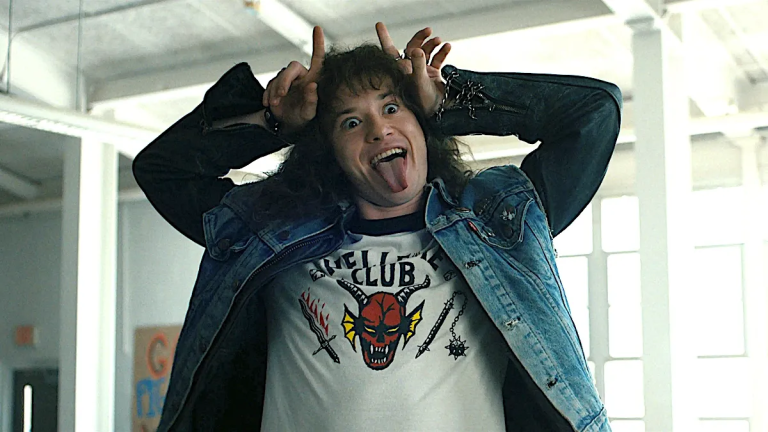 Eddie Munson makes devil horns in Stranger Things