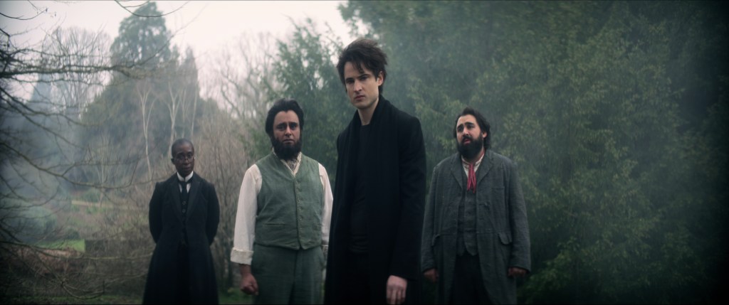 The Sandman. (L to R) Vivienne Acheampong as Lucienne, Sanjeev Bhaskar as Cain, Tom Sturridge as Dream, Asim Chaudhry as Abel in episode 102 of The Sandman. Cr. Courtesy of Netflix © 2022