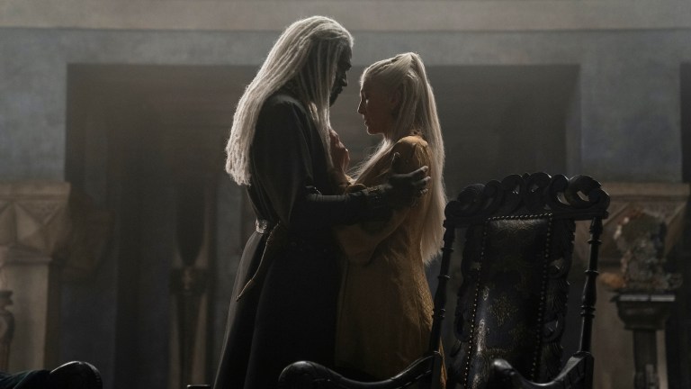 This article contains mild House of the Dragon episode 1 spoilers. Is it an insult or compliment? When a young Baratheon lord utters it during a joust in the first episode of House of the Dragon, it lands as both: “The Queen Who Never Was.” Baratheon makes this comment toward Rhaenys Targaryen (Eve Best), the oldest living grandchild of the long dead King Jaehaerys Targaryen. She once was favored by several households, including the Baratheons and the Starks, to be Jaehaerys’ heir during the Great Council of Harrenhal—she is, after all, the daughter of Jaehaerys’ oldest son and his Baratheon wife. Yet the patriarchal lords of Westeros felt differently, voting 10-to-1 in favor of Jaehaerys’ oldest living male grandchild, and the progeny of his second son: Viserys (Paddy Considine). The bulk of House of the Dragon’s premiere occurs nine years after that fateful decision, with Rhaenys seemingly content with her current station as cousin to the king and wife of Lord Corlys Velaryon (Steve Toussaint), the richest man in Westeros. Yet on the day a Baratheon quips he will joust for the honor of Rhaenys, the Queen Who Never Was, it all comes flooding back. And, perhaps like their characters, actors Best and Toussaint have distinctly different readings of what that unofficial title means. “Shame,” Best tells Den of Geek. “It’s such a blow. For her it’s absolutely the biggest humiliation that she ever suffered in her life. It’s like a core wound, and it’s horrendous every time it’s brought up.” Indeed, Best notes that Rhaenys has likely heard this phrase uttered privately and across the vast expanse of a throne room many times, and she always must smile and ignore it—to do otherwise risks perceptions of treason and possible death. “But on a personal level, it’s also so painful each time it’s brought up, and so embarrassing dealing with that kind of rejection on a public stage, day after day after day.” According to Best, Rhaenys’ shame is even the thematic engine of the series. Says Best, “Practically the first thing [showrunners Ryan Condal and Miguel Sapochnik] said to me when we were meeting was that this was the central drive of this particular story. As I later say to Rhaenyra, ‘Men would sooner put the realm to the torch than see a woman ascend the Iron Throne.’ And you can take the word ‘iron’ from that sentence and you have something that’s completely relevant today, ridiculously relevant.” While Toussaint agrees that Best’s assessment reflects how Rhaenys construes their daily lives (and perhaps our own), it is not necessarily the truth felt by her husband Corlys, who competes against Lord Otto Hightower (Rhys Ifans) for status as the second most powerful man in Westeros. “He’s aware of the humiliation that his wife feels and so he therefore doesn’t bring it up,” Touissant says, “but he doesn’t find it humiliating. I think for him, every time it’s said, it’s a dig at the king. It’s a reminder to the king that someone better qualified is here and should be where you are.” By playing the head of House Velaryon, Toussaint steps into the role of one of the most intriguing and, for fans who’ve only watched Game of Thrones, most mysterious power players in House of the Dragon. After all, by the time the events of Game of Thrones began, House Velaryon had all but vanished from the board. But during the time of Viserys and Rhaenyra (Milly Alcock), House Velaryon is perhaps the most trusted contemporary of the mercurial Targaryen dynasty. Like the Targaryens, the Velaryons originally hail from Old Valyria, settling along the Blackwater on the island of Driftmark at least a generation before the Targaryens took up residency at what became known as Dragonstone. And it was from Velaryon ships that Aegon Targaryen I’s army unloaded on what would become King’s Landing. House of the Dragon co-creator Condal tells us that Lord Corlys could very well match the power of a familiar menace from Game of Thrones. “I've long described the Velaryons as the Lannisters of this particular time period,” says Condal. “They're the richest and most politically influential house other than the crown in this world. So Corlys at this point is kind of our Tywin Lannister.” By summoning the ghost of Charles Dances’ Tywin on Game of Thrones, Condal is suggesting we’ll see echoes of how every Southron house and lord sought favor from Casterly Rock. However, as Toussaint cautions, such similarities in power and influence do not mean an alignment of temperaments. In fact, throughout much of House of the Dragon’s premiere, Corlys appeared to be the only member of the King’s small council willing to speak his mind candidly. “Honorable” is one word Toussaint uses to describe Corlys. “There is something to be said of someone [who] made his fortune himself, gone out and earned it. Yes, he’s part of nobility, but his house was on the slide until Corlys went out and did these nine legendary voyages. So I think that gives him a certain nobility. He feels that he, amongst many of his peers, deserves to be there because he worked to be there. Some of these people just were born into it. They were, as he says to Daemon in episode two, ‘They were given their fortunes. You and I had to create ours.’ And I think that’s something he wears like a badge. But it also fuels his resentment.” That impending connection to Daemon is interesting, too, since Corlys is the only one who defends Daemon’s claim to the right of succession when his rival Ser Otto begins poisoning the king against his brother. However, Toussaint doesn’t fully agree when we suggest Corlys likes defending the unpopular causes. “He’s a very forthright, almost ramrod-like straight man,” says Toussaint. “This is the law. So at the time that we meet, we’ve never had a woman on the Iron Throne, therefore that’s not a possibility. [Viserys] has no male heir, no children, so the next male heir is Daemon. We all know it; it’s the law. And that’s what his thing is. It doesn’t matter if I like Daemon; whether I think Daemon would be a great king or not; the law is that that’s who it is.” Although Toussaint teases we will see Corlys and Daemon “coming together to fight a common cause” in the coming weeks. Still, going back to that jousting scene where Corlys and Rhaenys sit from on high and feign they didn’t hear “the Queen Who Never Was” be shouted yet again, there remains a sense aloofness to this power couple—and a self-awareness that might be akin to a Greek chorus in such a luxuriant and decadent context. “It speaks to our feeling like outsiders,” Best says, "both of us, even though we’re very much inside because of being of high ranking nobility, and you being the richest man in the world. But we’re also spiritually and temperamentally, and experientially, outsiders.” She adds, “I think that as a template for this particular incarnation of the Game of Thrones, the Dance of the Dragons, Greek tragedy feels very [apt]. Not only in the content being quite Greek in terms of the scale, and the craziness and intensity that goes on, but also that structural element.” Hence both actors welcome that in House of the Dragon, their characters take on echoes of a Greek Chorus. Well that “or the two old guys in the Muppets,” Toussaint quips. House of the Dragon is playing on HBO and HBO Max now.