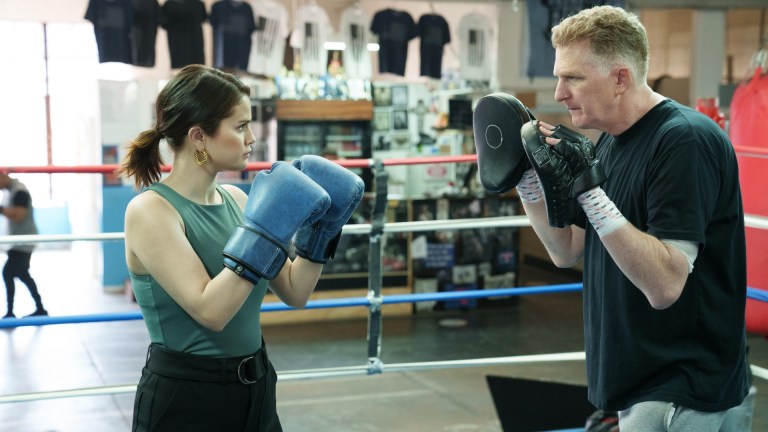 Only Murders In The Building -- “Sparring Partners” - Episode 209 -- Closing in on the killer, Mabel takes her investigative talents into the ring. Oliver and Charles duke it out over a birdcage only to end up confronting their deepest paternal struggles. Mabel (Selena Gomez) and Detective Kreps (Michael Rapaport), shown.