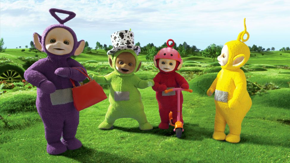 Tinky Winky appearing on the Teletubbies carrying a red handbag