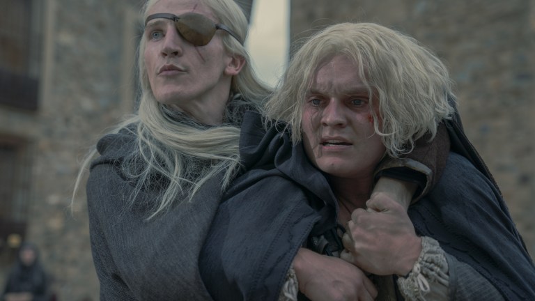 Aemond Targaryen (Ewan Mitchell) holds his brother Aegon Targaryen (Tom Glynn-Carney)