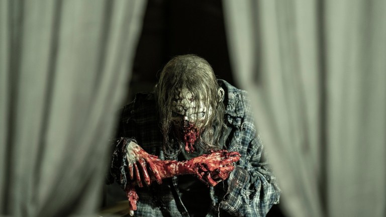 A walker enjoys a snack on The Walking Dead season 11 episode 24.