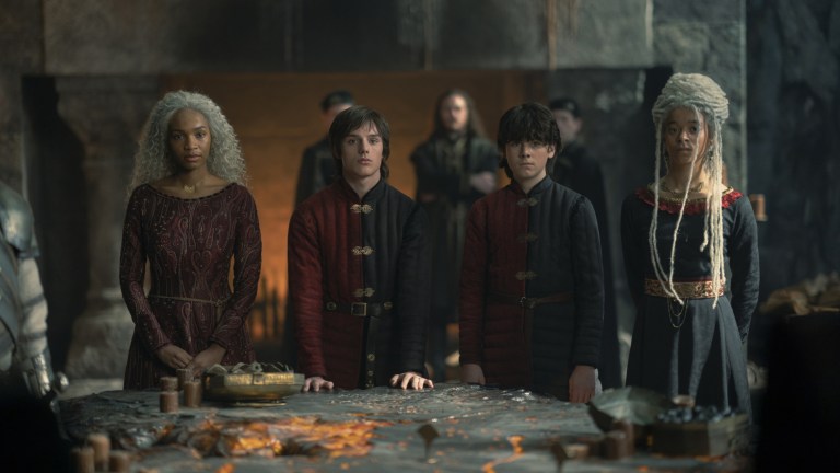 Baela Targaryen (Bethany Antonia), Jace Velaryon (Harry Collett), Lucerys Velaryon (Elliot Grihault), and Rhaena Targaryen (Phoebe Campbell) gather around the lit table at Dragonstone in House of the Dragon