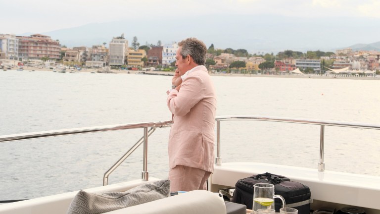 Tom Hollander on a yacht in The White Lotus season 2