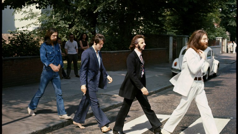 The Beatles crossing in a zebra crosswalk at Abbey Road Studios