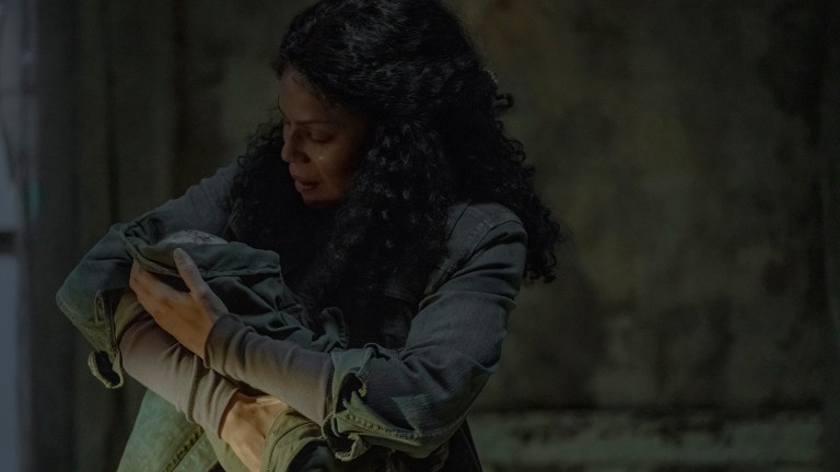 Marlene (Merle Dandridge) holds baby Ellie in an abandoned farmhouse in HBO's The Last of Us