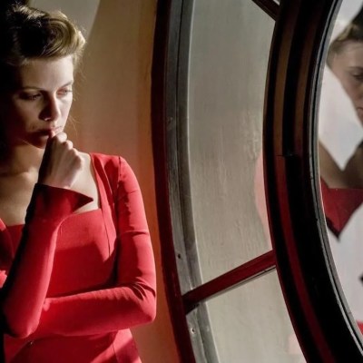 Melanie Laurent in Inglourious Basterds in red red dress next to swastika