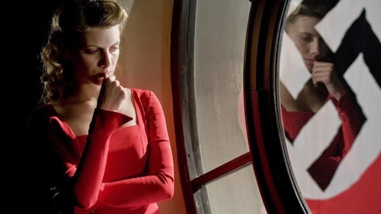Melanie Laurent in Inglourious Basterds in red red dress next to swastika