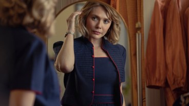 Elizabeth Olsen as Candy Montgomery looks at herself in the mirror