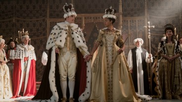 Corey Mylchreest as Young King George, India Amarteifio as Young Queen Charlotte, Michelle Fairley as Princess Augusta attend a royal coronation in episode 103 of Queen Charlotte: A Bridgerton Story