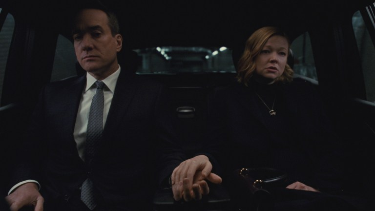 Tom (Matthew Macfadyen) and Shiv (Sarah Snook) sit in the back of a car barely holding hands